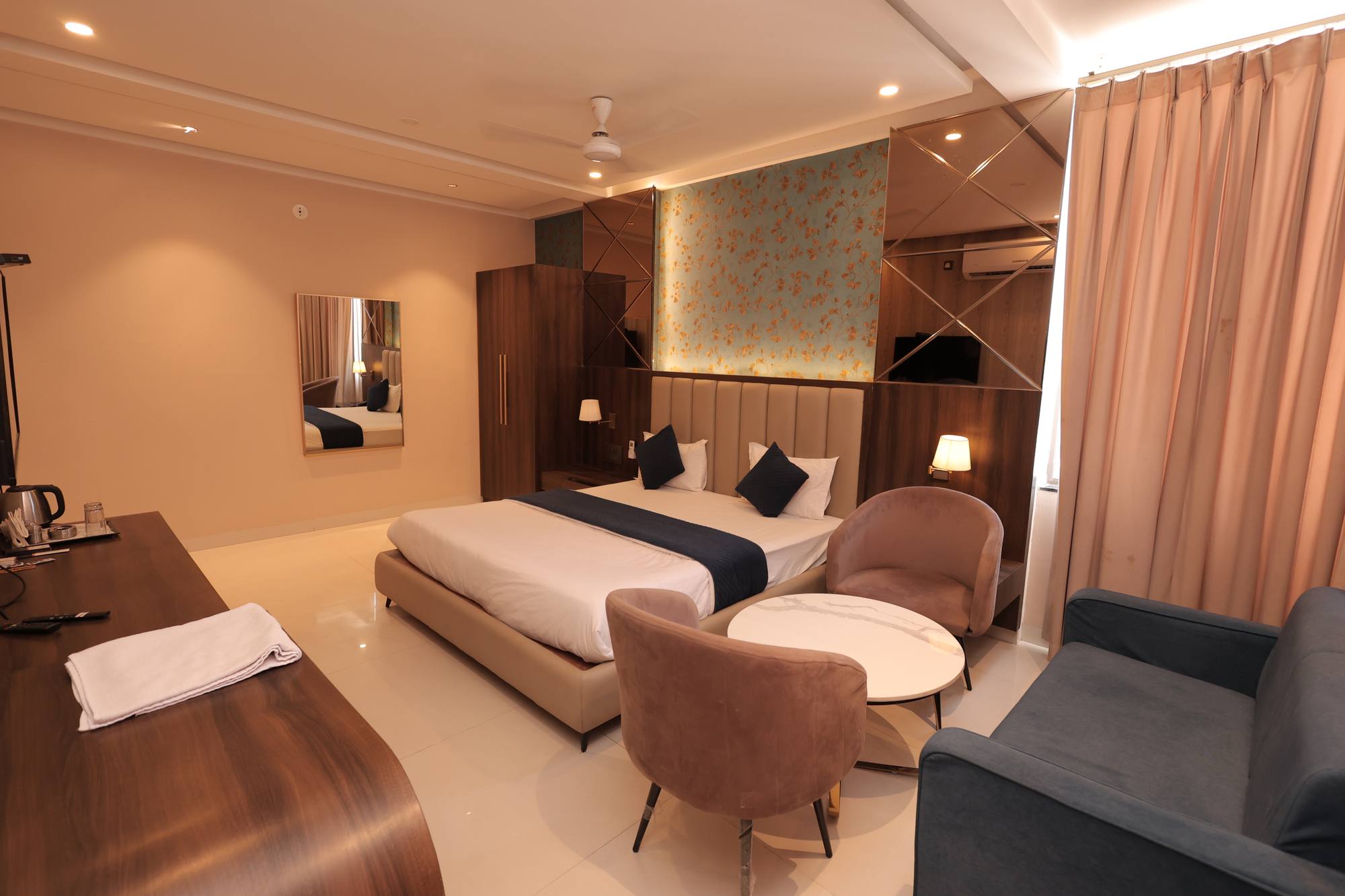 The seating area in the Premium Room at Hotel Relax Inn, with armchairs and a low table